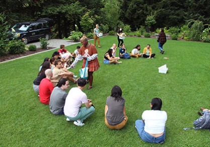 Group of students sitting outside on the grass
