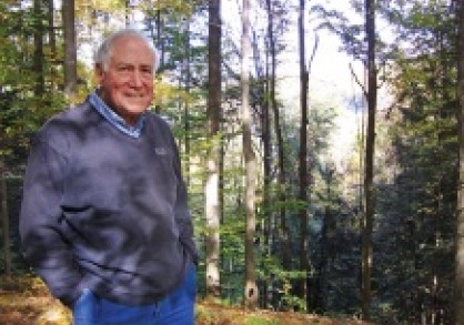 David Bandler stands in forest