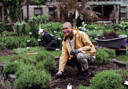 a person kneeling in a garden