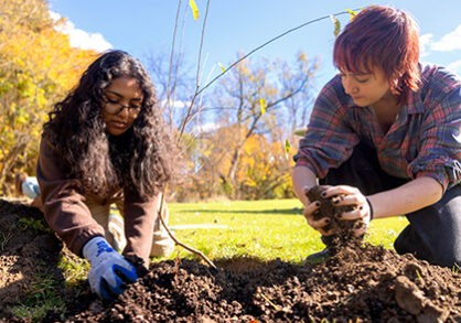 Two students planting a garden